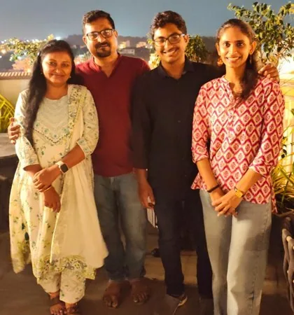 Anarghya with Ruthuparna and his parents on a rooftop at night