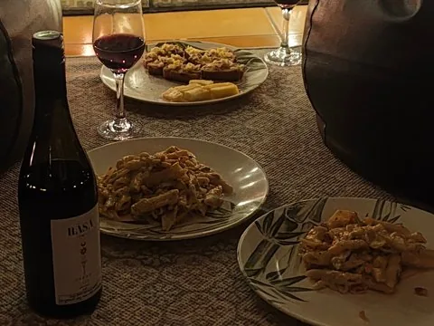 Home-made pasta and wine on a rug by candlelight